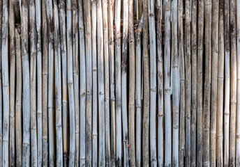 Fototapeta premium Old bamboo plank fence texture material construction for background.