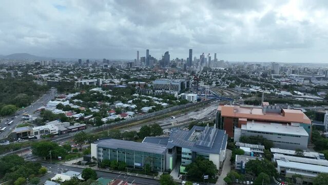 Establishing push in drone shot of Brisbane City from above Dutton Park. Revealing Boggo Road Prison and Brisbane South State Secondary College. Shot on cloudy morning.