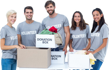 Digital png photo of diverse volunteers holding donation boxes on transparent background