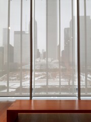 Winter snow city view through window blinds