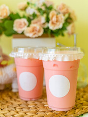 A cup of Thai pink milk tea on the table