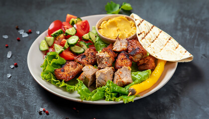 Healthy barbecued lean cubed pork kebabs served with a corn tortilla and fresh lettuce and tomato...