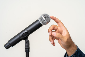 Knock knock Close up finger testing microphone voice. Before speaking or singing.