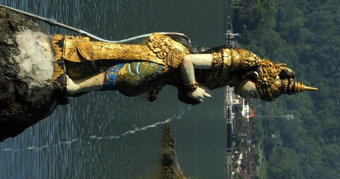 Vertical static shot of religious hindu statues at danau batur at water temple on bali indonesia in slow motion