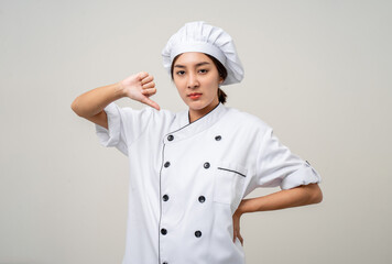 Irritable angry emotional Unhappy annoyed Young beautiful asian woman chef in uniform on isolated background. Cooking woman Occupation chef or baker People in kitchen restaurant and hotel.