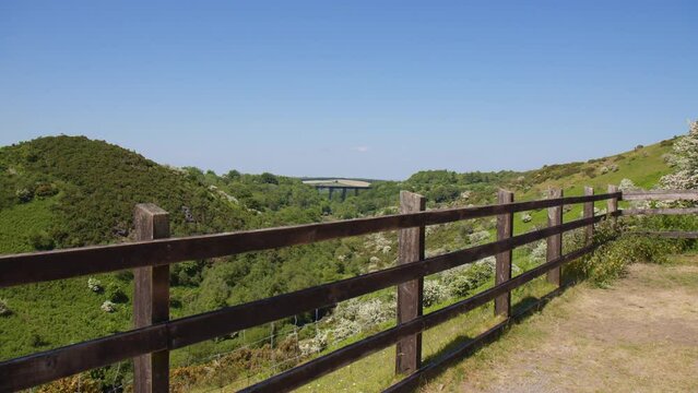 Panoramic Pan Over Countryside Fencing with Historic Meldon Viaduct in the Distance, Dartmoor on a Sunny Day