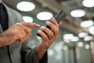 Young man holding using smartphone on urban city background.