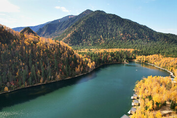 Emerald Lake in autumn. Aerial view. Tourist houses, an Orthodox Chapel on the lake shore on a...