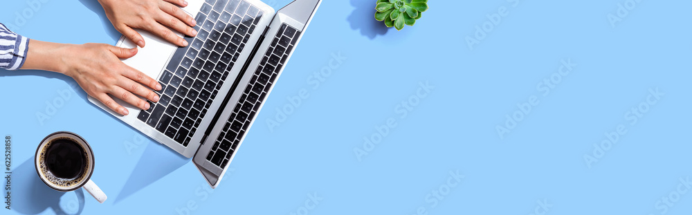Poster person using a laptop computer from above
