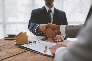 Handshake of real estate brokers with customers or investors, mortgage loan agreements Make a lease-purchase-sell house and home insurance mortgage loan concept.