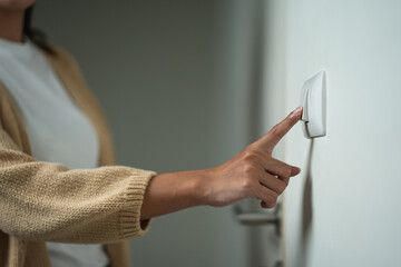 Earth Hour Close up woman finger turn off or on the light to saving electrical energy. Finger...