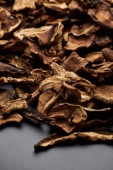 Close-up of dried porcini mushroom slices on moving platform