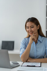 Businesswoman using a laptop computer with documents Calculator, notebook, on the table, planning, analyzing financial reports. business plan investment financial analysis concept