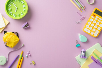 Embark on the educational process with this top-view photograph showcasing copybooks, clock and...