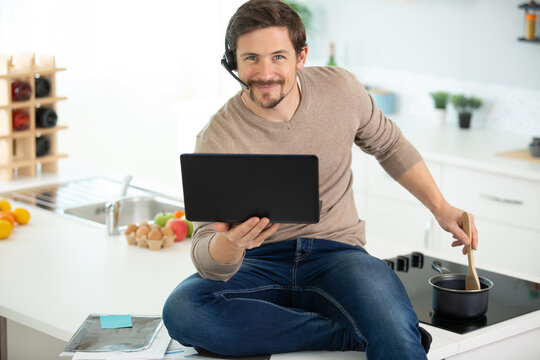 Man Cooking In The Kitchen While Working