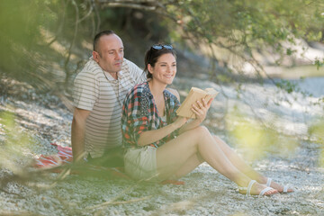 beautiful happy mature couple hugging near lake