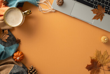 Autumn-themed freelance setup featuring a laptop, coffee cup, cozy scarf, and rustic decor of pumpkin candles, maple leaves and pinecones on brown background, ideal for text or advert placement