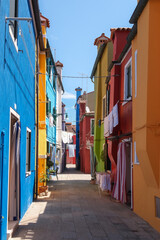 Fototapeta na wymiar Burano Island, Venice, Italy - June 22, 2023: Colorful house facades on Burano Island