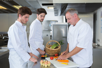 young chefs training with experienced professional