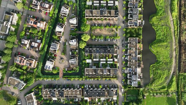 Neat Dutch housing project integrated into natural water-rich environment, drone