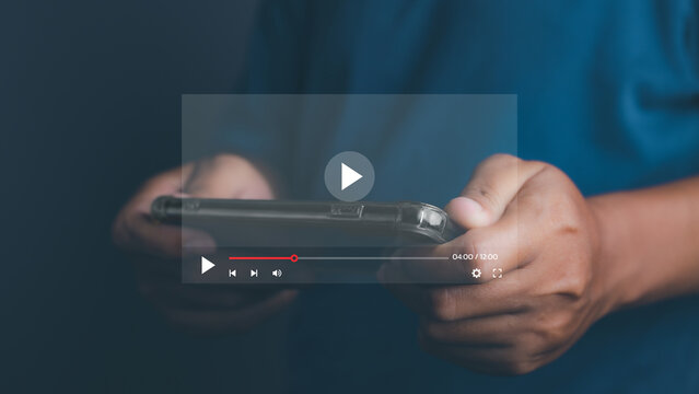 Man playing video game on his mobile phone. Online movie streaming with smartphone. Person watching video on internet with an imaginary video player service.