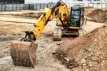 Large crawler excavator at the construction site. Close-up of an excavator bucket with the boom...
