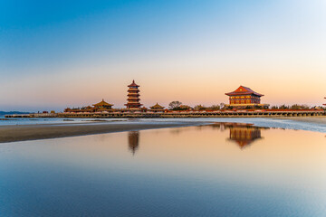 The Eight Immortals crossing the sea reflected in the sea water of Penglai Beach