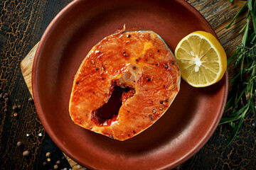 Marinated salmon steak in a clay plate. Delicious seafood