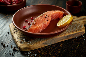 Marinated salmon steak in a clay plate. Delicious seafood