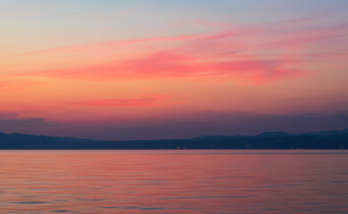 Naklejka na ściany i meble Sunset sky with red cloud above sea and distant hill. Travel, nature background, Croatia, island Krk