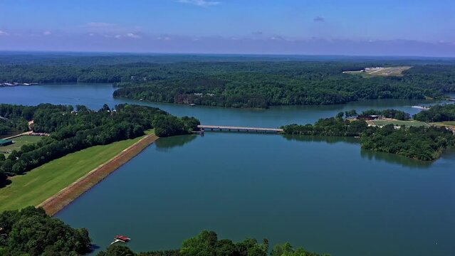 Aerial shot of a lake and wooded areas crossed by a bridge Clemson, SC. University Square Shopping Center. Lake Hartwell. Drone aerial shot 