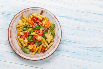 Italian pasta adorned with fresh tomatoes and aromatic basil
