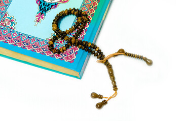 Holy Quran and prayer beads with white background. isolated.