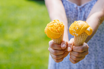 Refreshing ice cream in waffle cones with lemon flavour