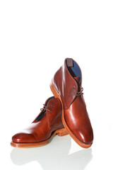 Footwear Concepts. Premium Tanned Derby Boots Made of Calf Leather with Leather Sole Placed On One Another On Pure White Background.