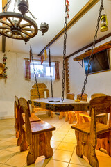 Modern Bathhouse or banya Interior. Line of Wooden Chairs and Furniture Located Inside of The Dining Room of Russian Banya.