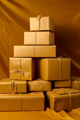 Stack of yellow wrapped presents sitting on top of brown table cloth. Generative AI.