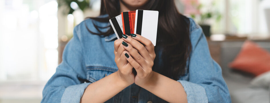 Woman looking at many credit card in her hands and worry about finance.
