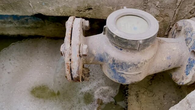Waste chemical water coming out from the dirty water meter pipe. Pouring water produce foam. Chemical waste water from industrial process. Wastewater Treatment Procedure (WWTP)