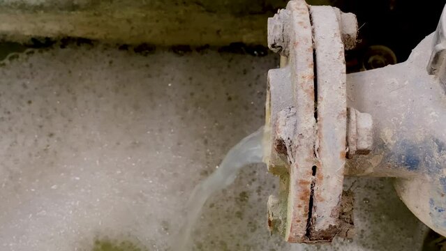 Dirty water coming out from pipe. Pouring water produce foam. Chemical waste water from industrial process. Wastewater Treatment Procedure (WWTP)