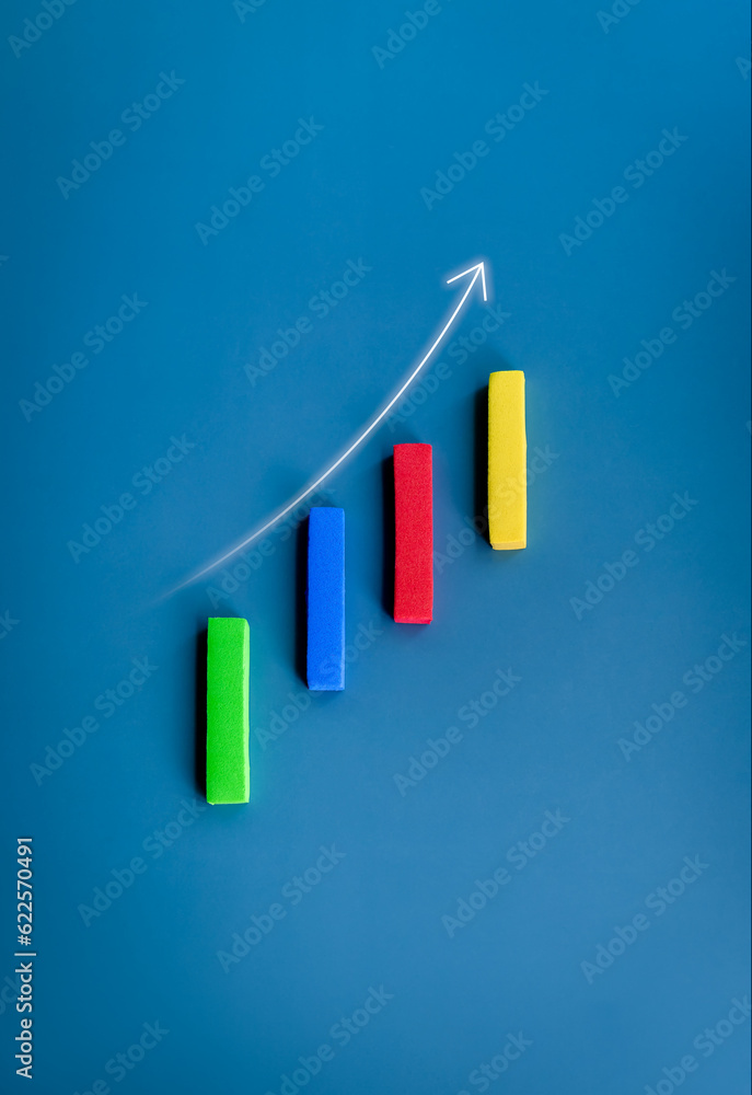 Poster rising up arrow on vertical multicolor block sticks as a business chart on blue background, minimal 