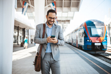 Modern business travel demands modern technology. Confident businessman talking on mobile phone...