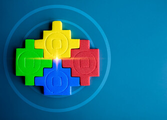 Obraz premium Four jigsaw puzzle blocks different colors are put together perfect on goal target icon on blue background, minimal style. Business partnership, teamwork, difference, unity and collaboration concepts.