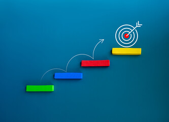 Curved line arrow jumping on colorful stair blocks from below to the target icon on the top block...