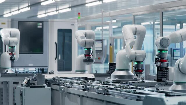 Advanced High Precision Robot Arms at Bright Electronics Factory. Fully Automated Modern PCB Assembly Line. Electronic Devices Production Industry. Component Installation on Circuit Board.