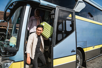 happy asian muslim passengers lined up in line to get off the bus © Odua Images