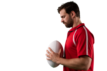 Digital png photo of caucasian male rugby player holding rugby ball on transparent background