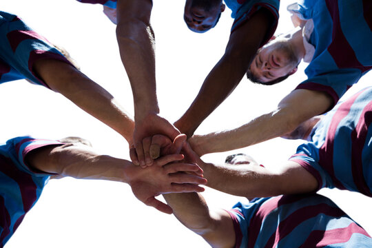 Digital png photo of diverse male rugby players teaming up on transparent background - Powered by Adobe