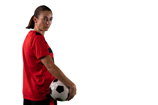 Digital png photo of biracial female soccer player holding ball on transparent background