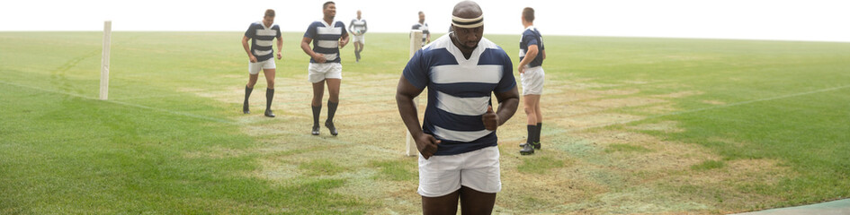 Digital png photo of diverse male rugby players at stadium on transparent background